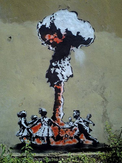 Banksy grafitti of children playing ring a a ring a rosy around an atomic mushroom cloud